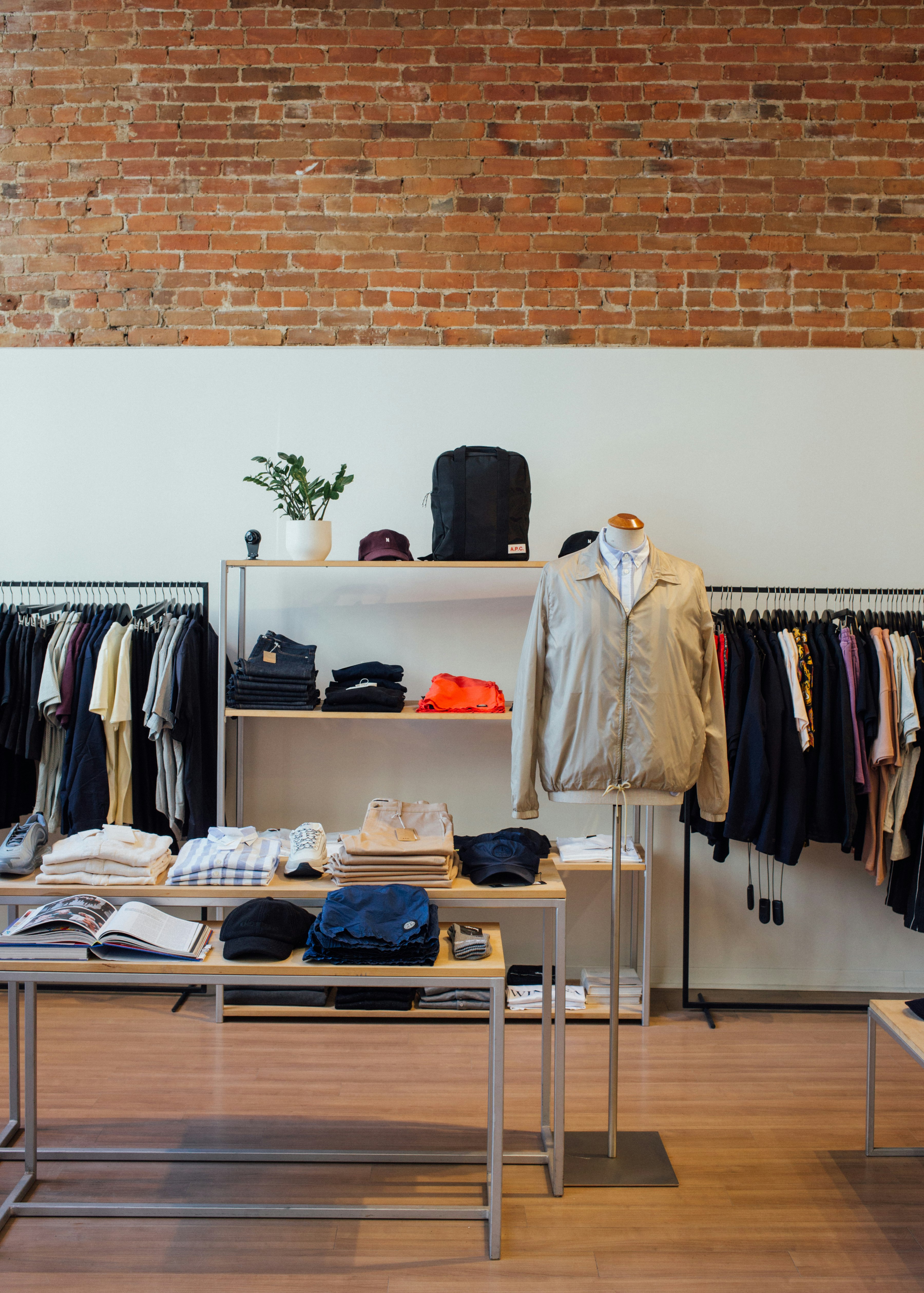 assorted-color clothes lot beside white wall